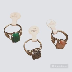 Women's jewelry size 8 rock rings. Includes green, black/white striped/clear.